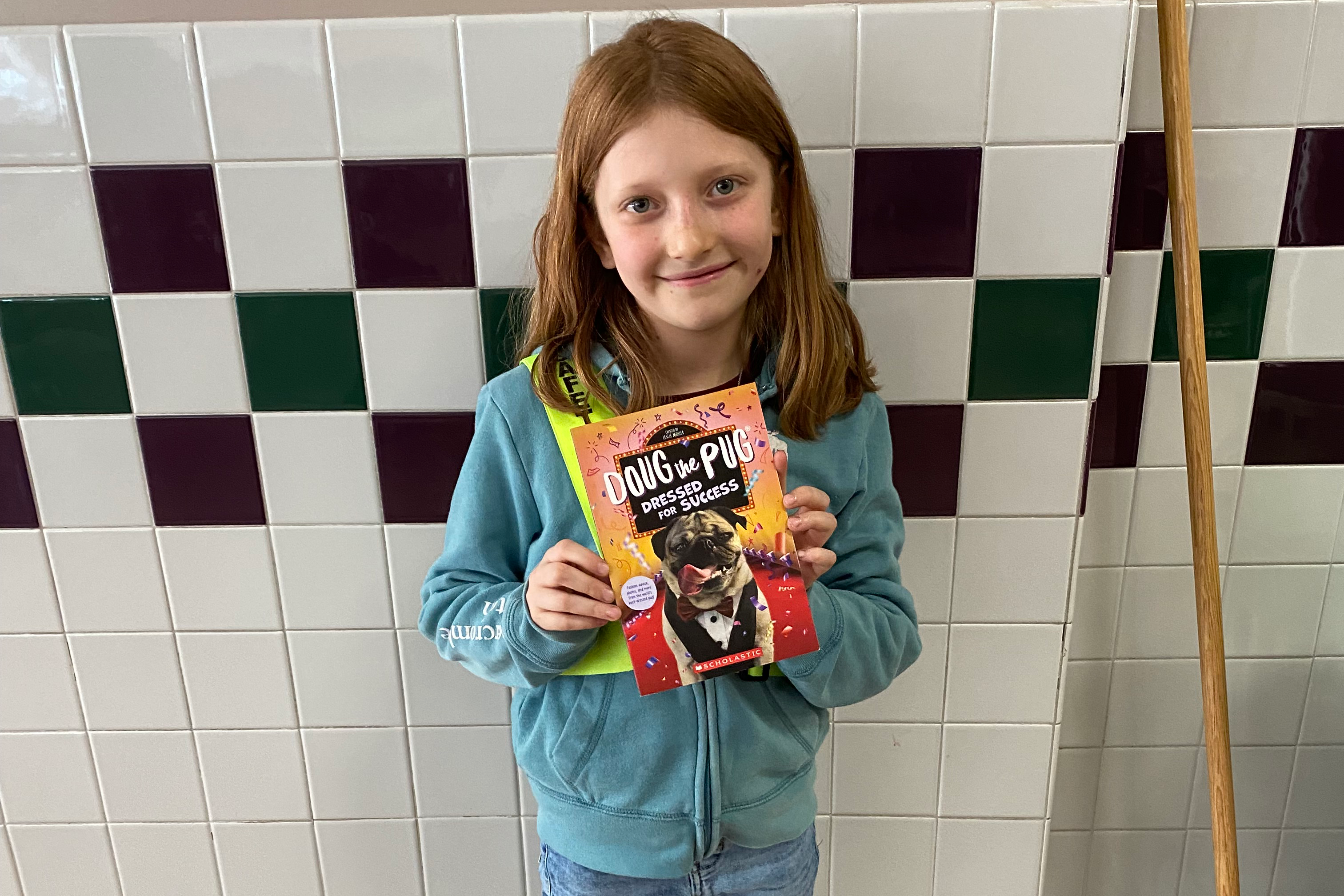 lucky tray winner poses with new book