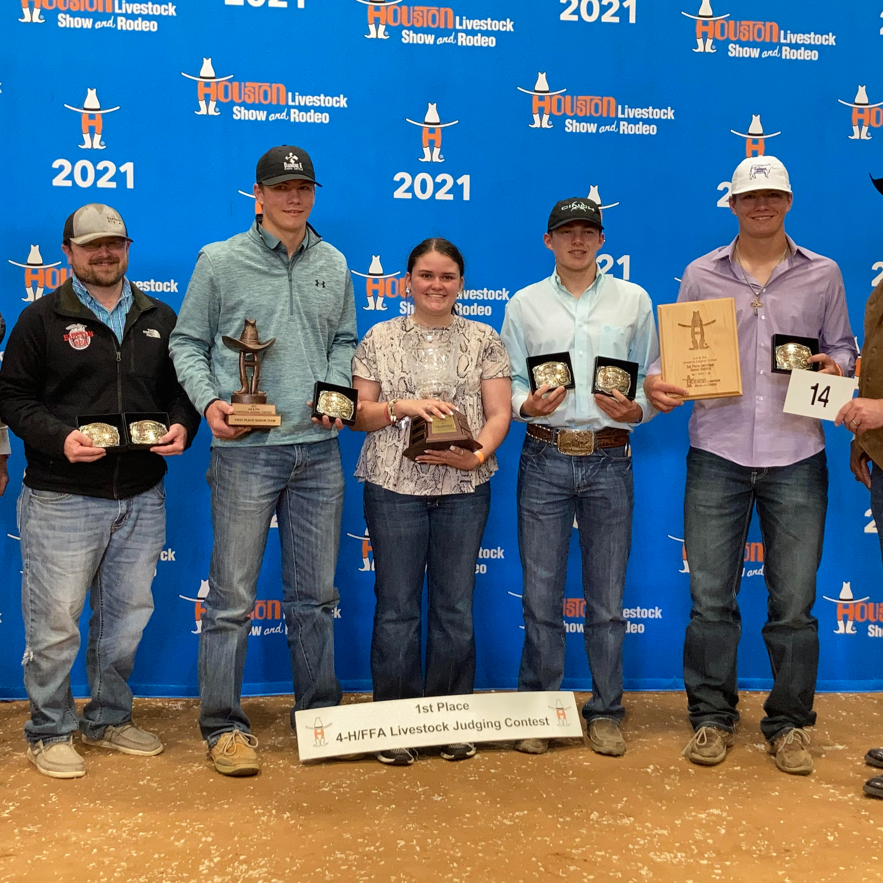 FFA  students hold their trophies/belt buckles they have won