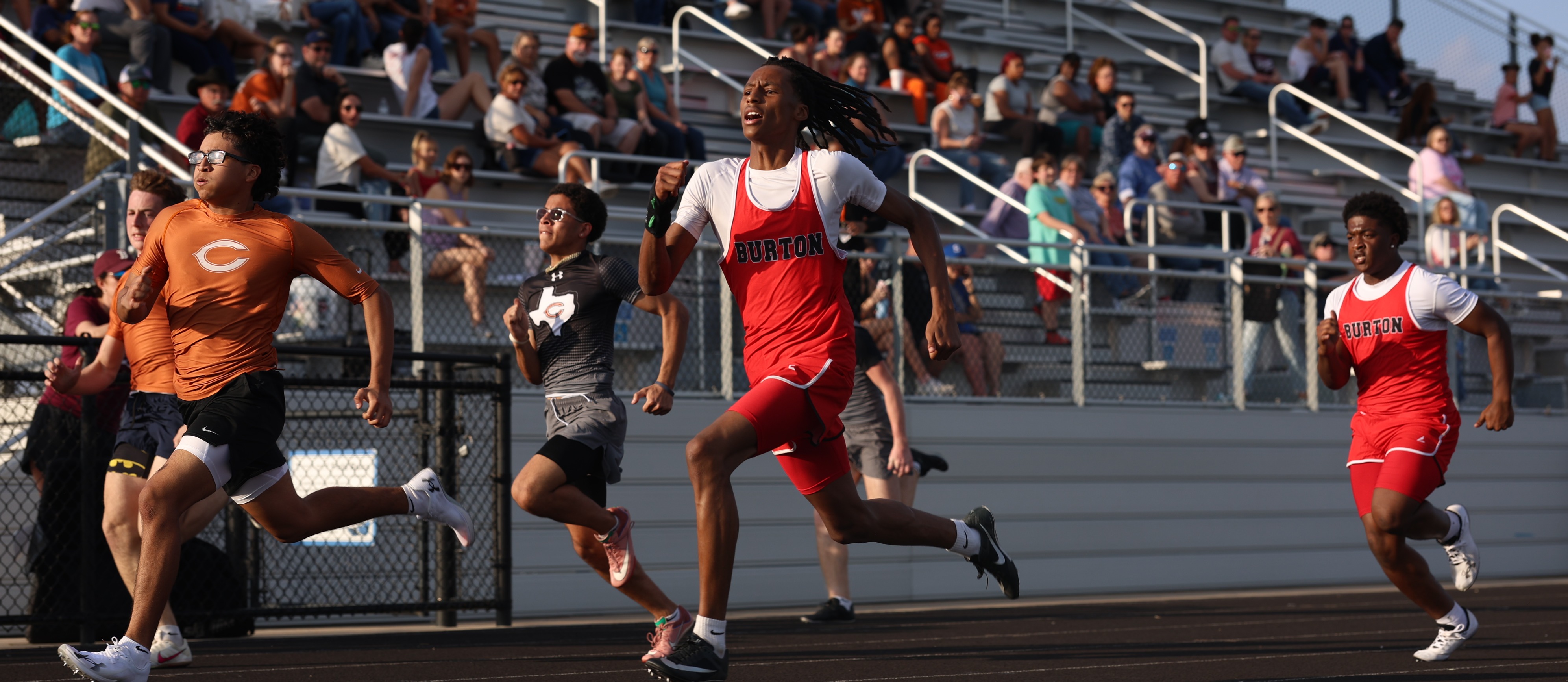 boy running track event
