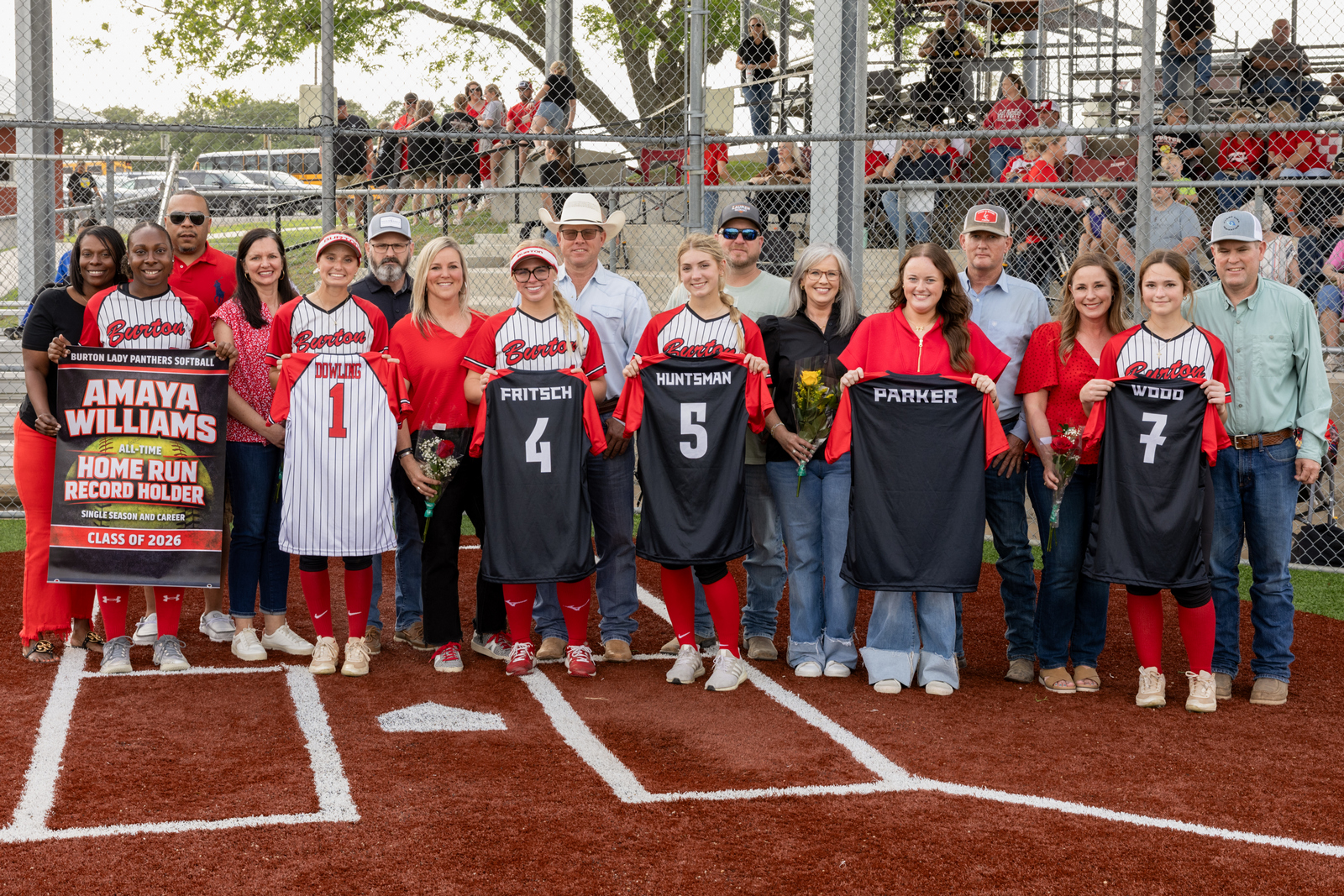 group of softball players with their parents