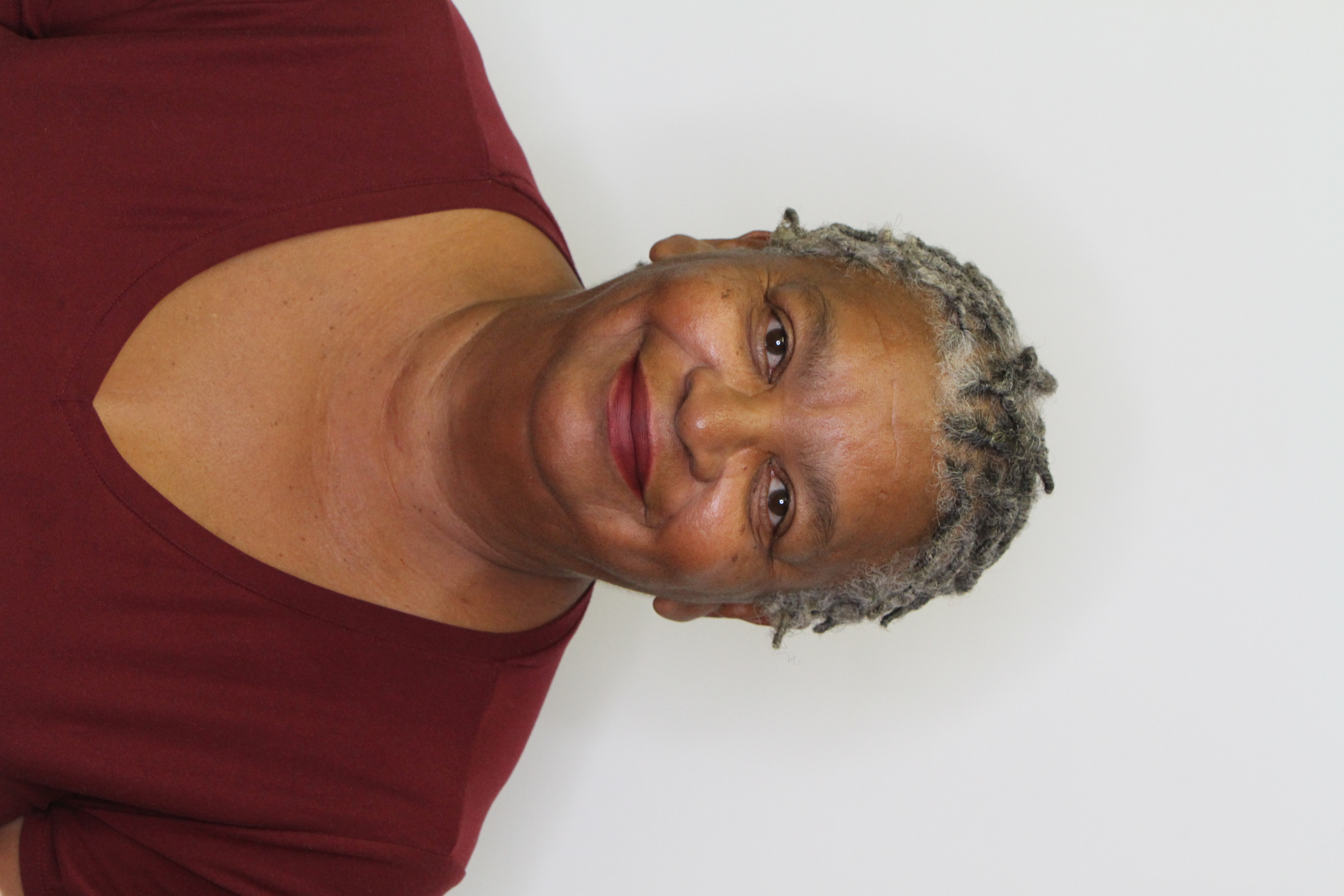 photo of black woman, short hair, burgandy shirt