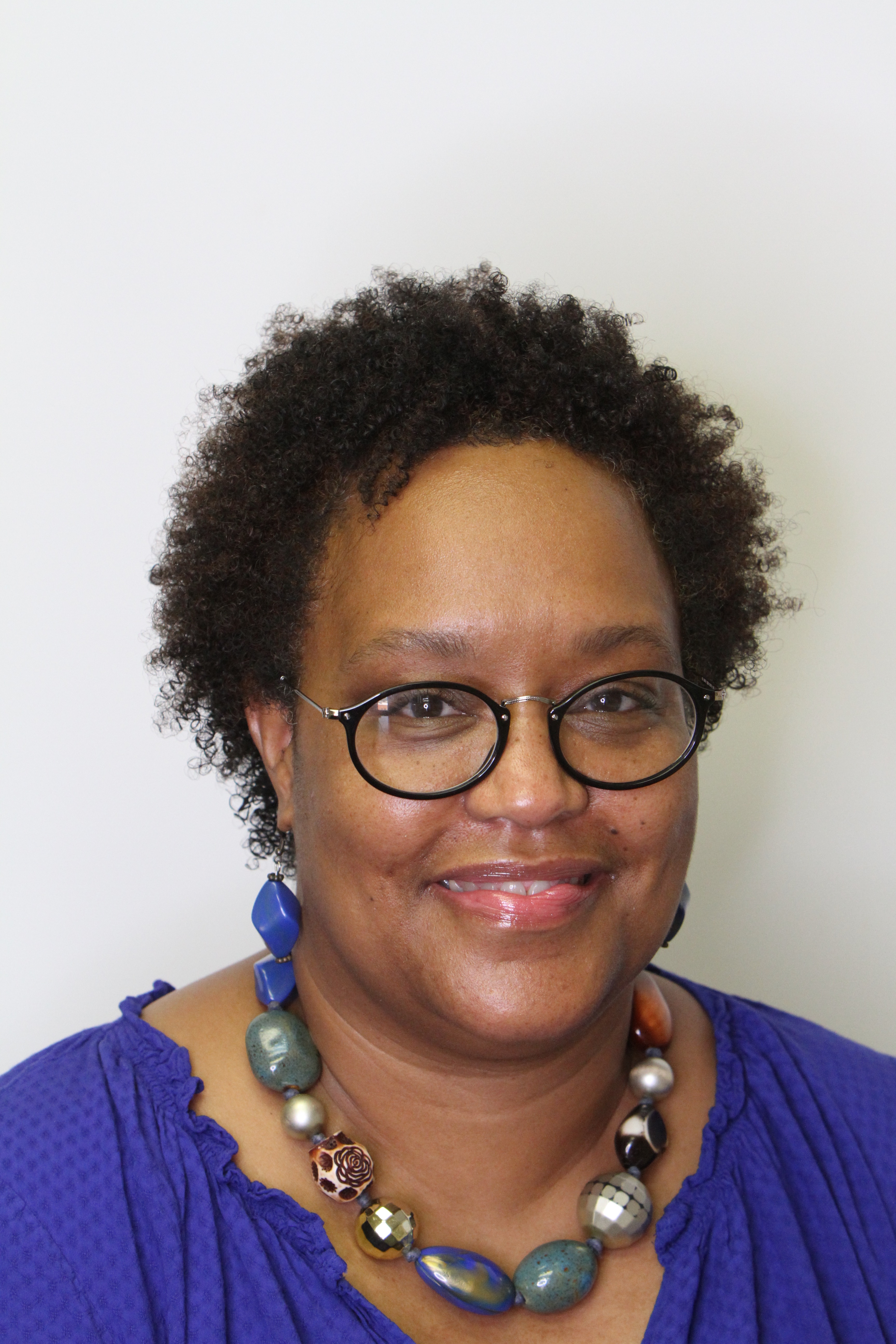 Photo of black woman, short hair, glasses