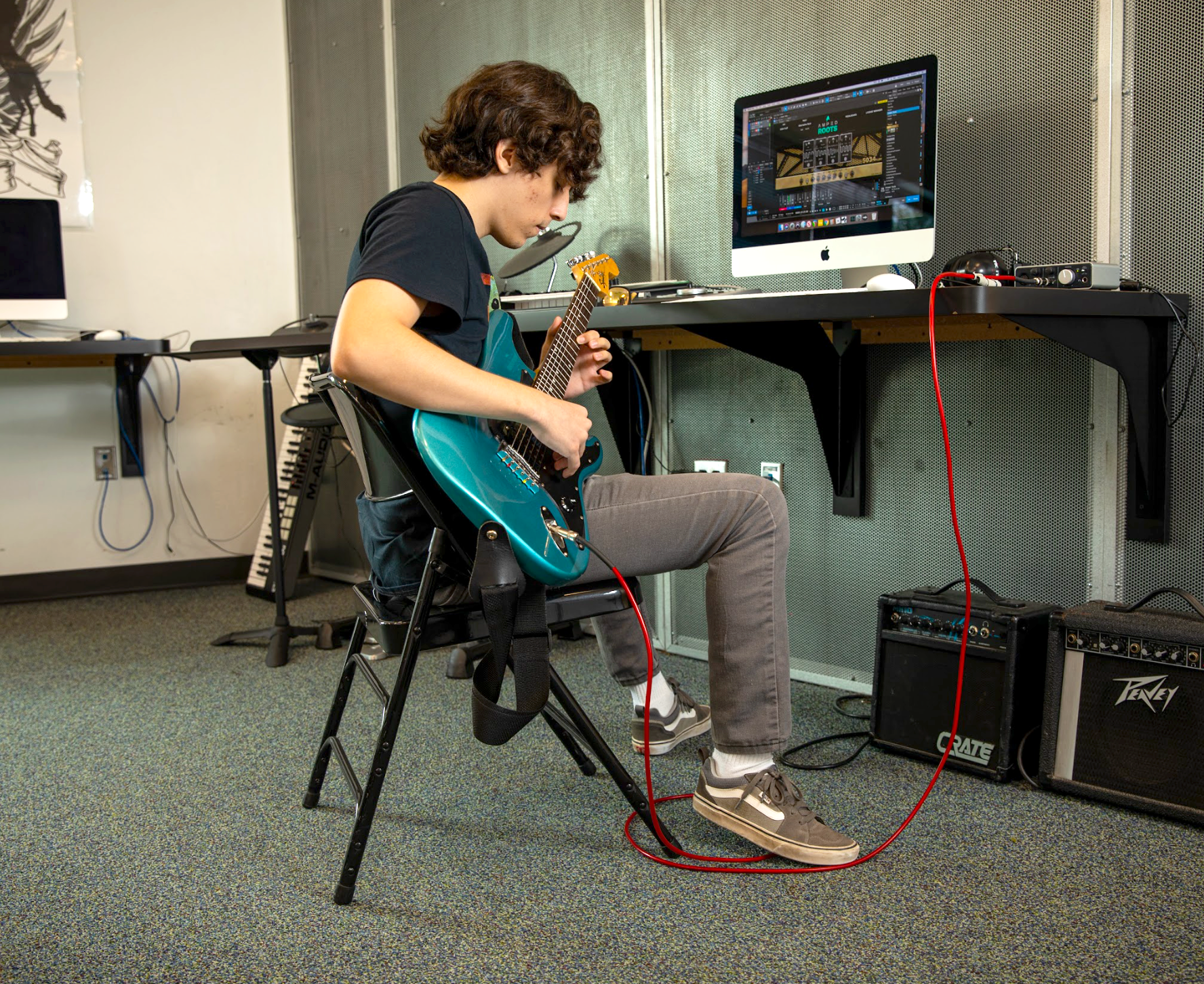 Student using guitar for sound