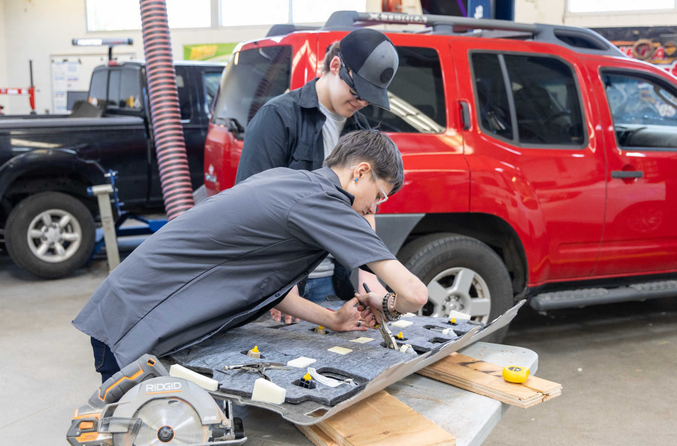 CTE students working on an interior panel of a car