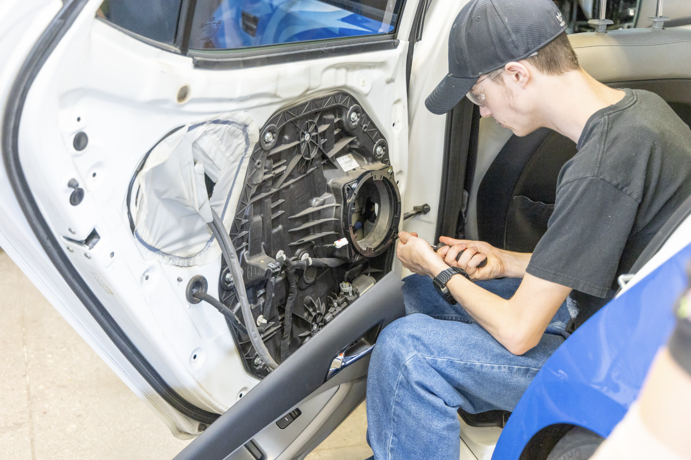 Student working on interior panel of a car