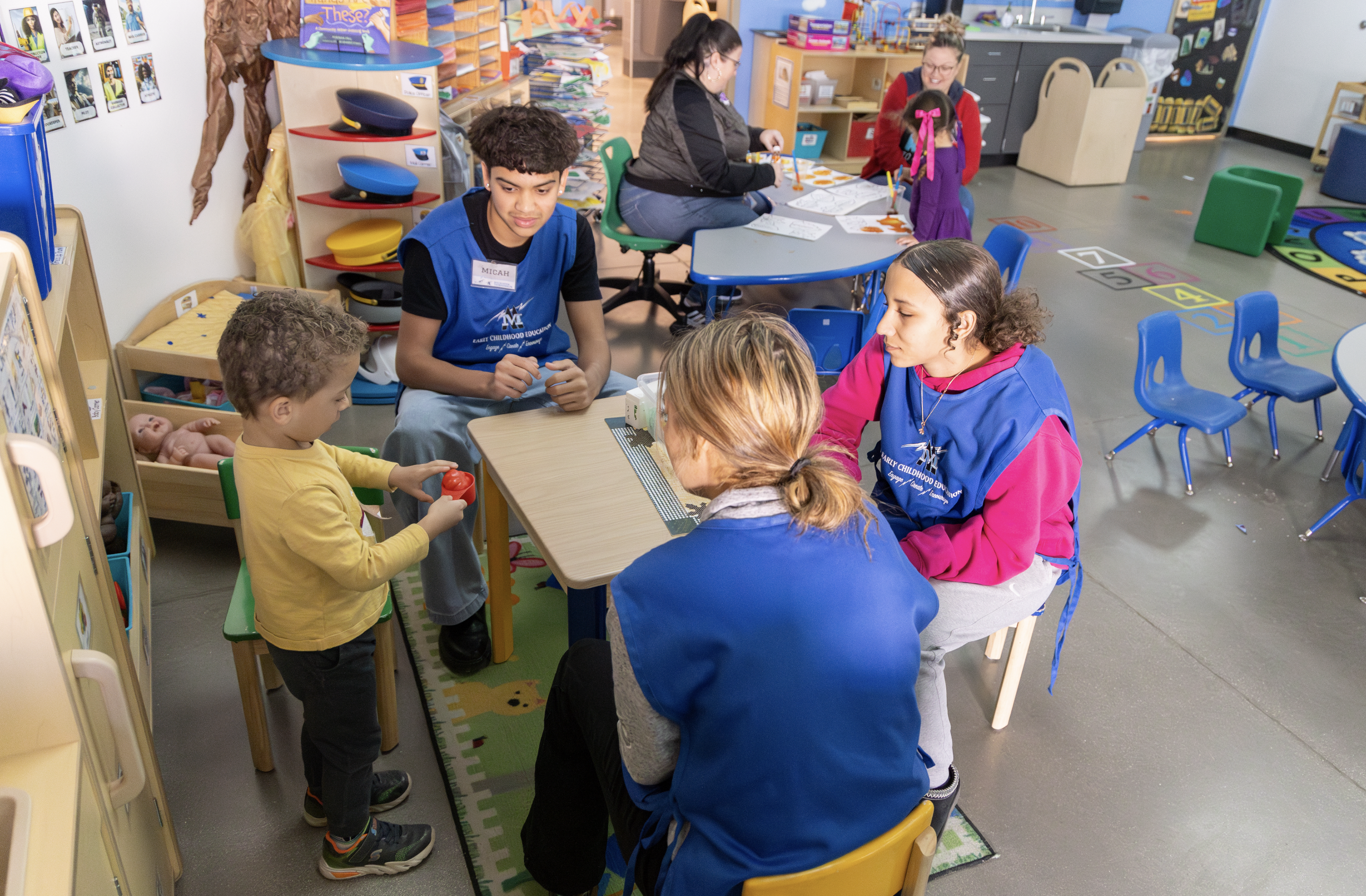 ECE Students playing with a preschooler