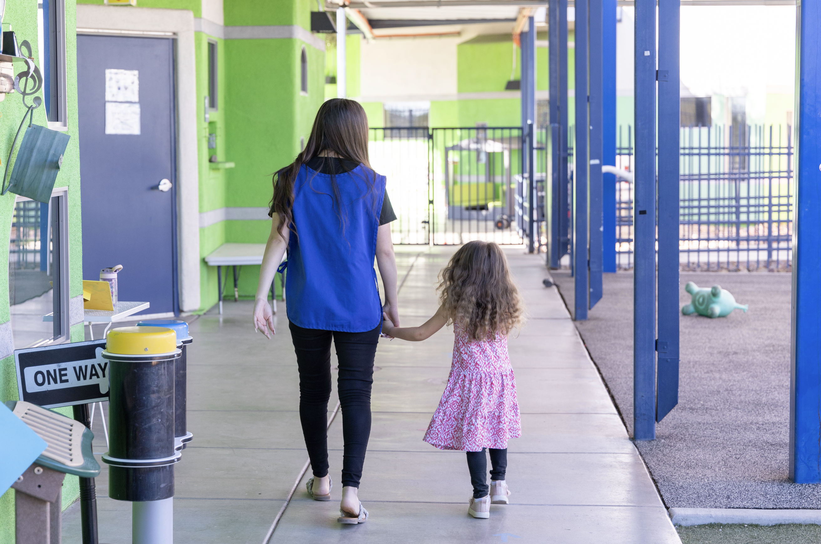 ECE Student walking with a preschooler