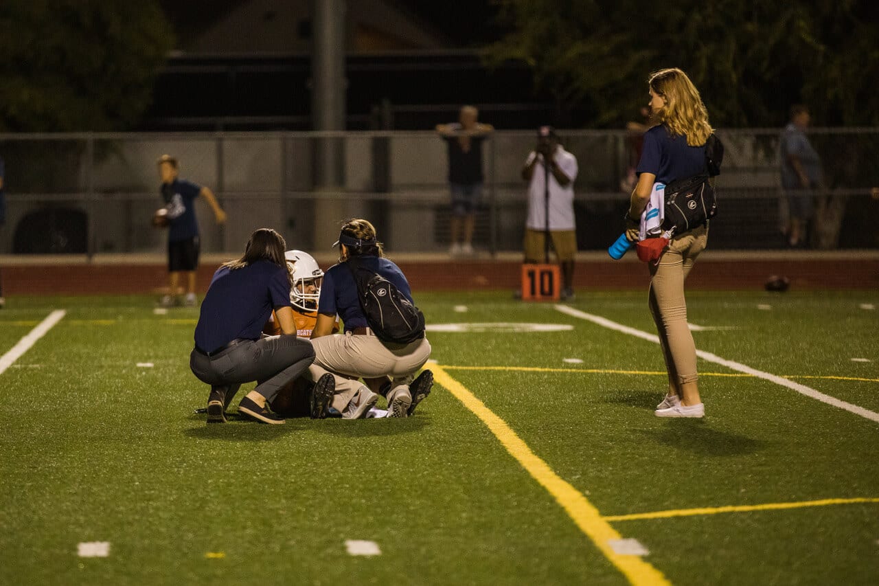 Students helping an injured player
