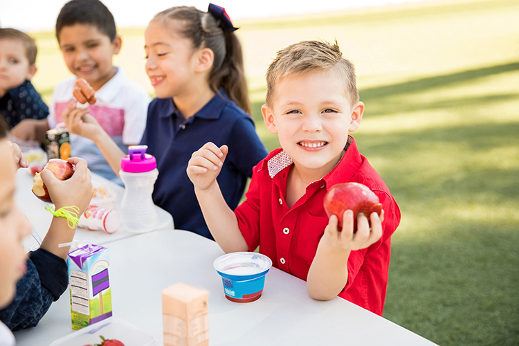 Smiling kid enjoying lunch