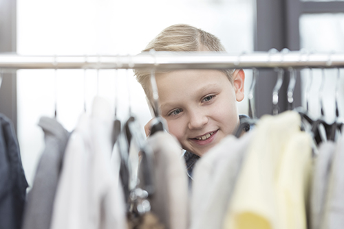 smiling boy shopping for clothes