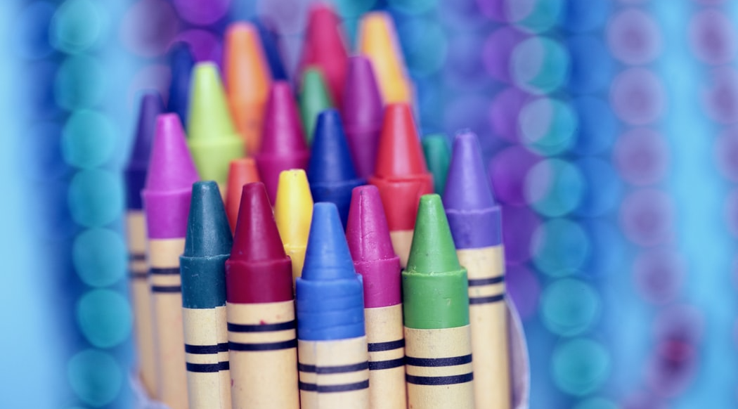 Crayons in in colorful background