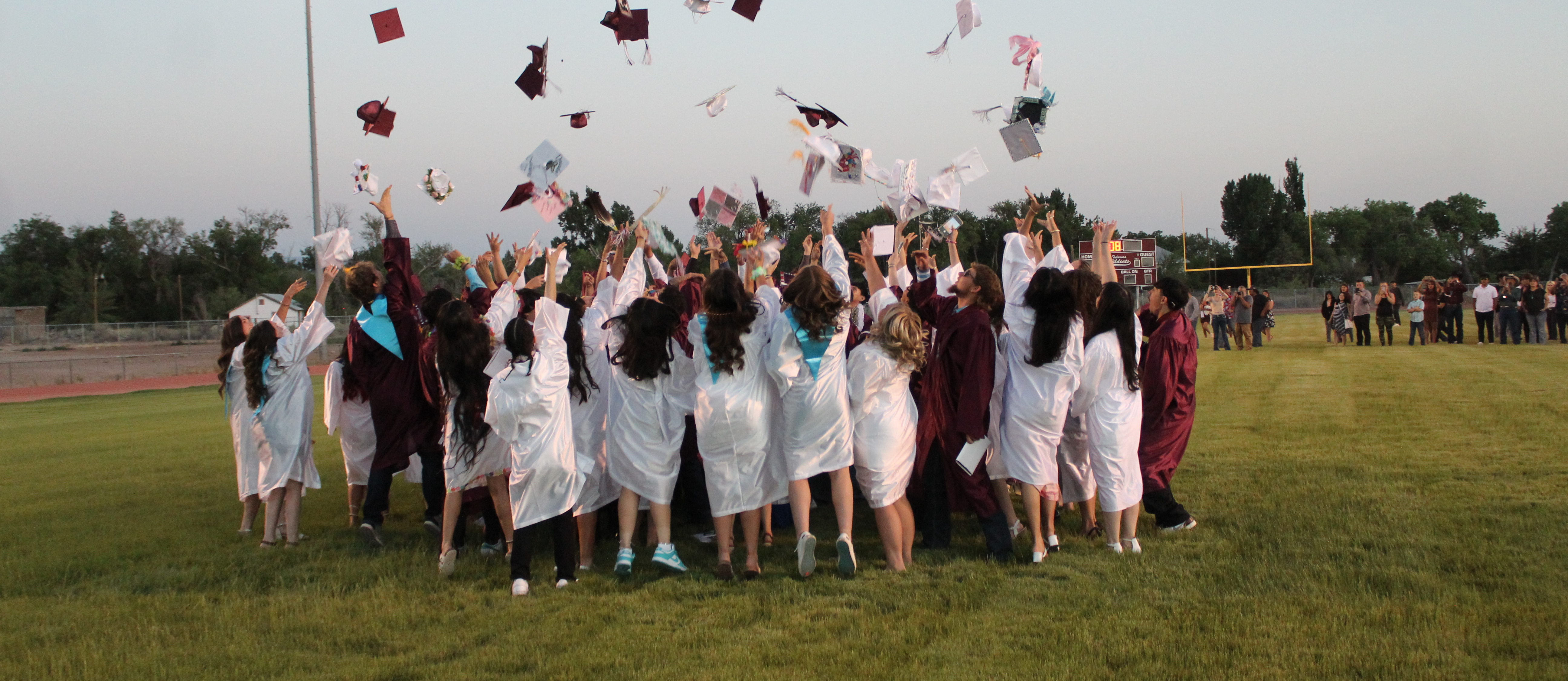 2024 Graduates throwing their caps