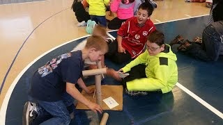 Kids making a makeshift rollercoaster