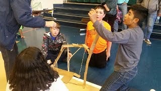 Kids making a makeshift rollercoaster