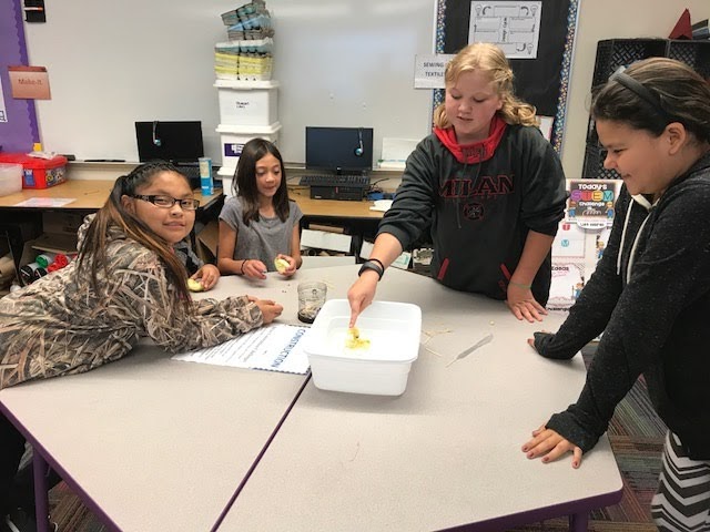 Student pushing an Apple Raft in a bucket