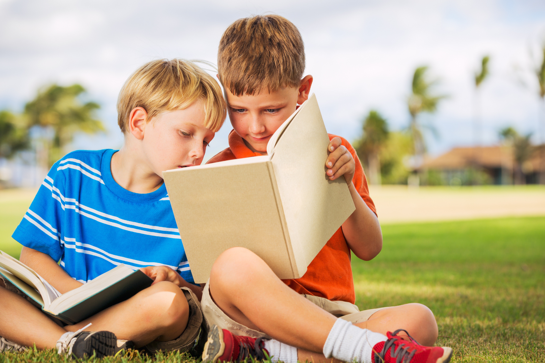 Tow boys reading outside