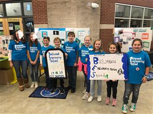 Group of kids holding two posters