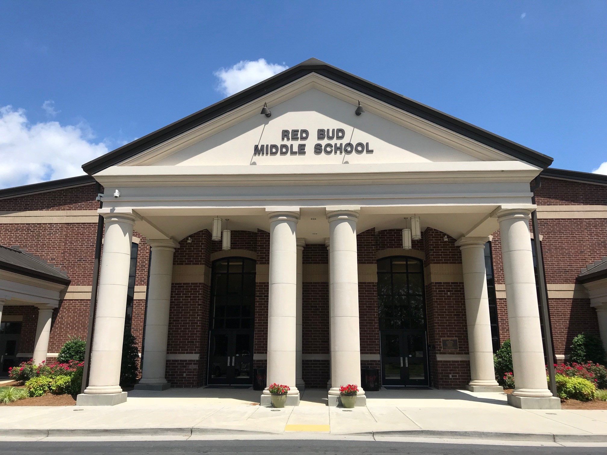 The front of Red Bud Middle School with blue skies behind.