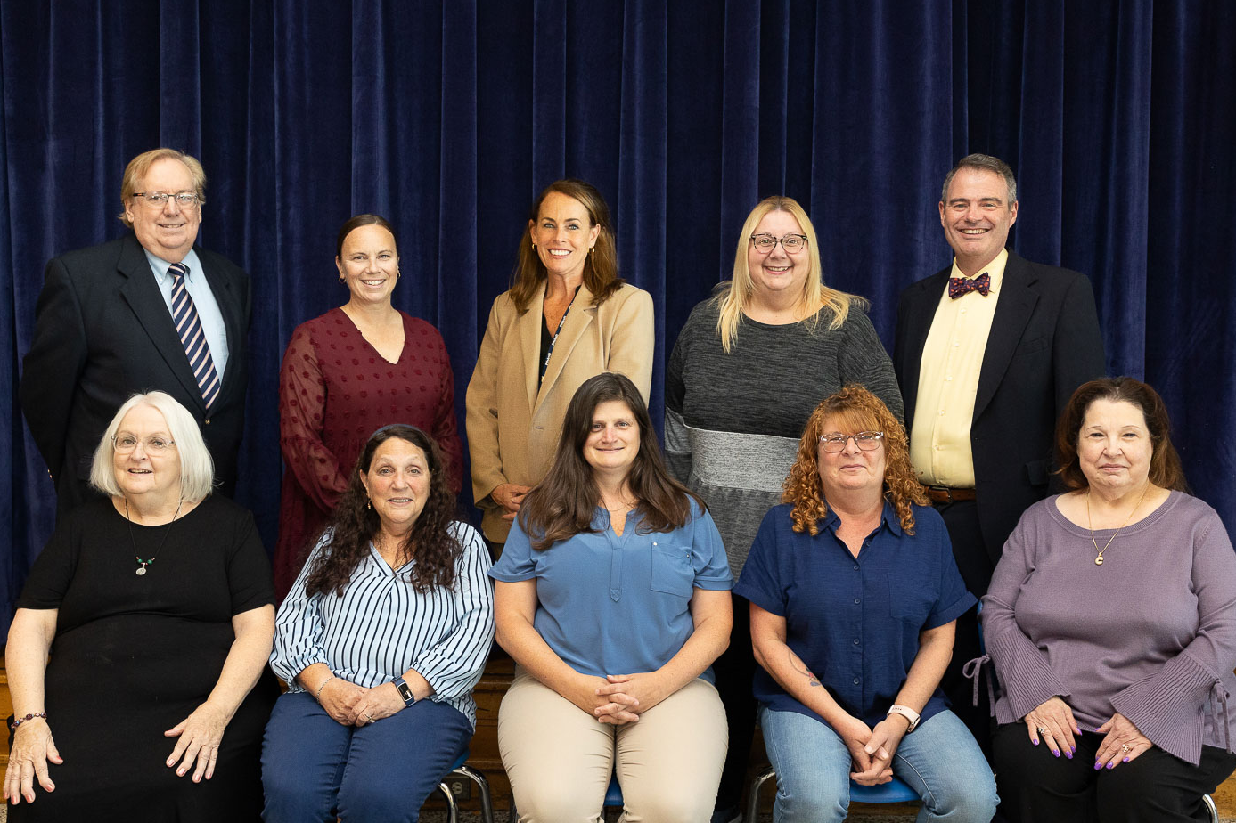 Board of Education Members and Superintendent standing on a staircase