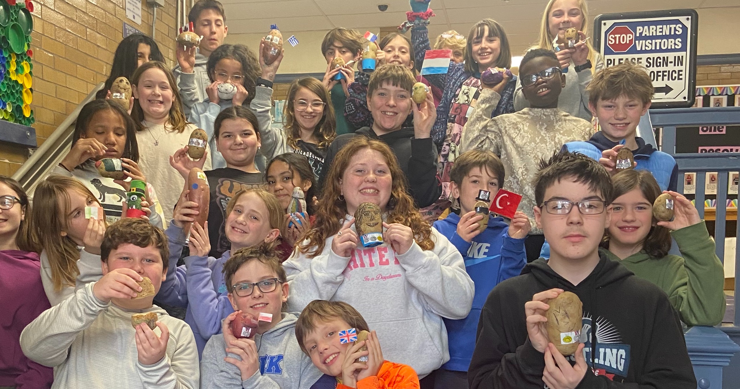 5th grade students posing with their potatoes for the potato olympics event