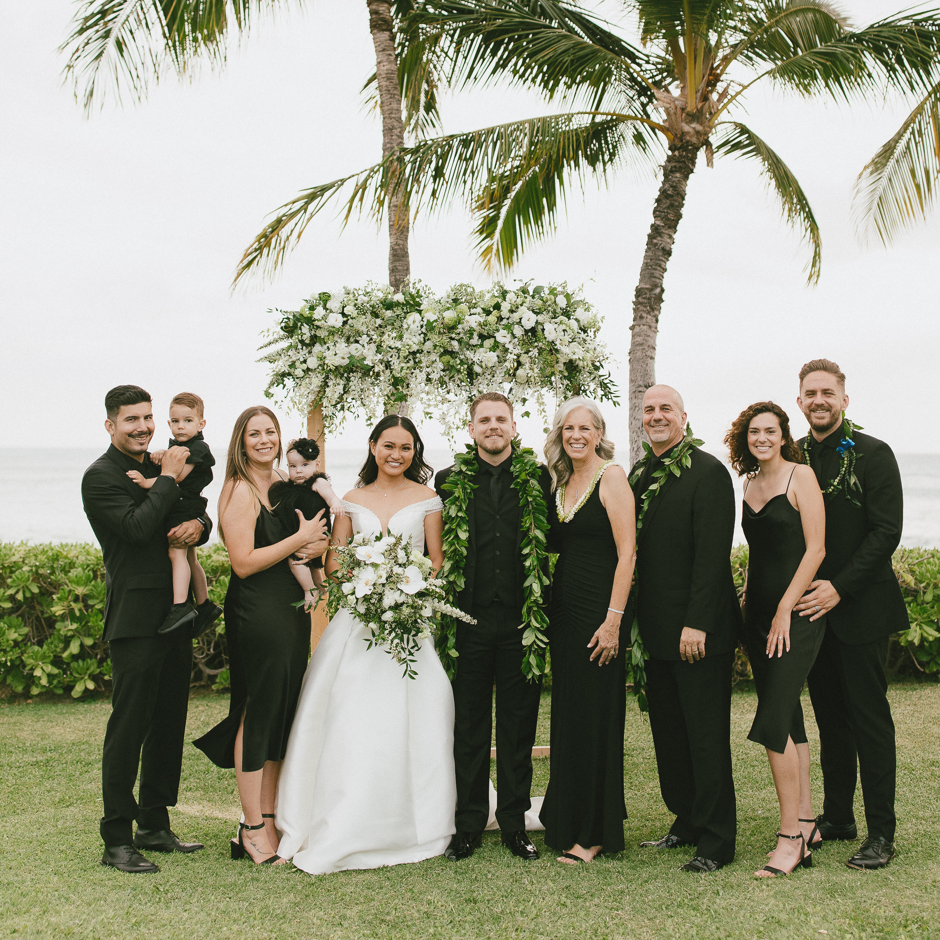 wedding photo of 10 adults and two babies in Hawaiian setting