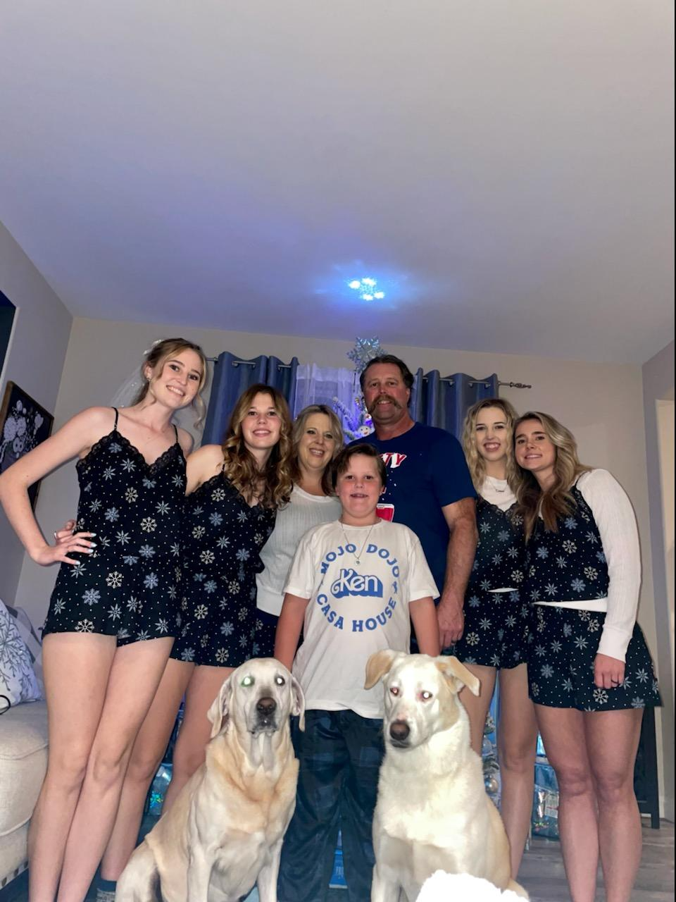 mrs. carmeans family all sitting on stairs with dog smiling