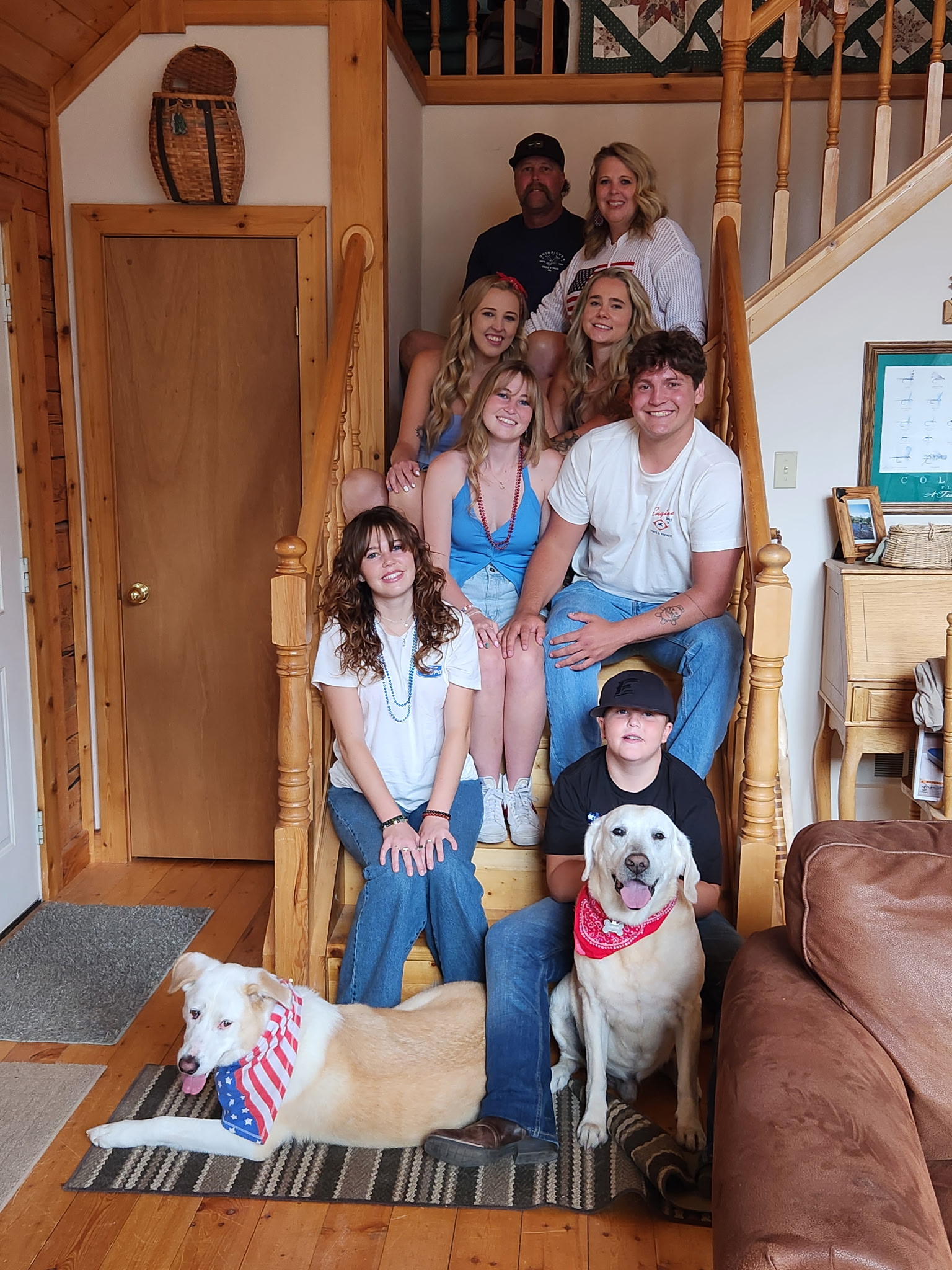 mrs. carmeans family all sitting on stairs with dog smiling