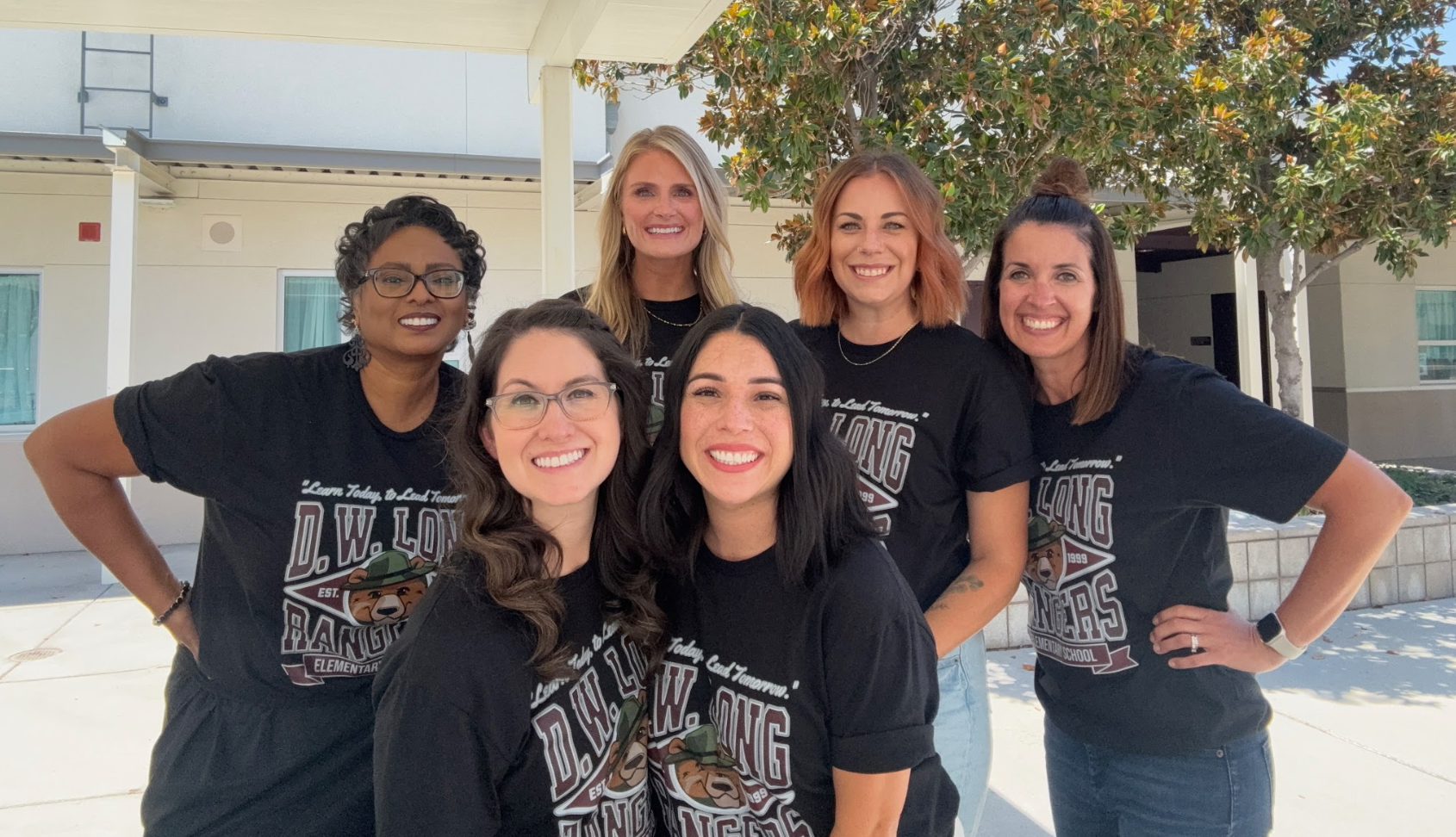 all of the second grade teachers smiling together