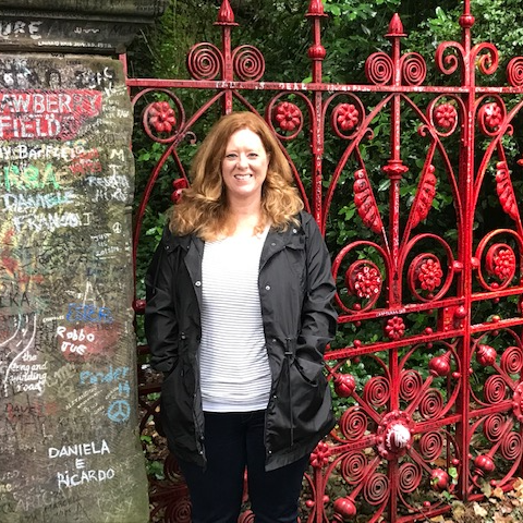 Mrs. Zollinger standing in front of a red fence
