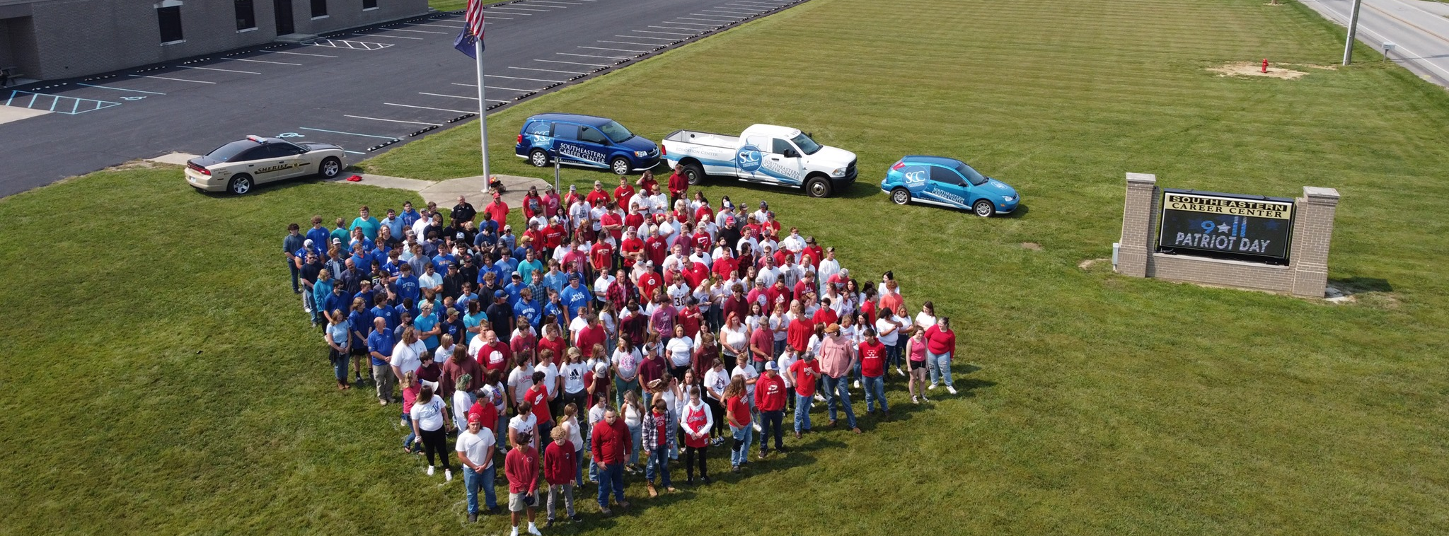 students standing in shape of american flag