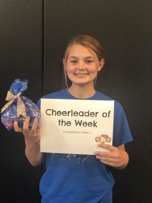 Abbey Napier receiving her award for Cheerleader of the Week