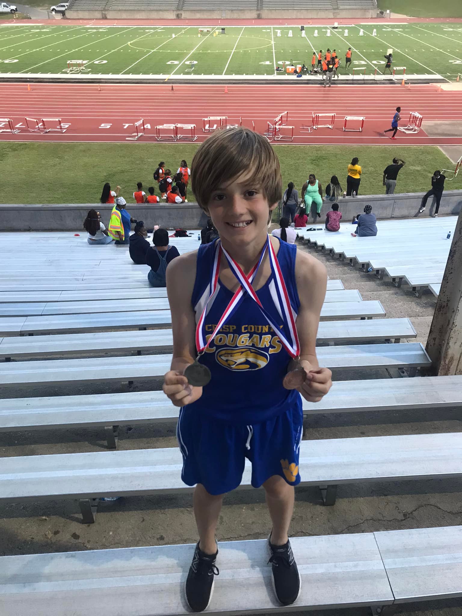 Track student with medal