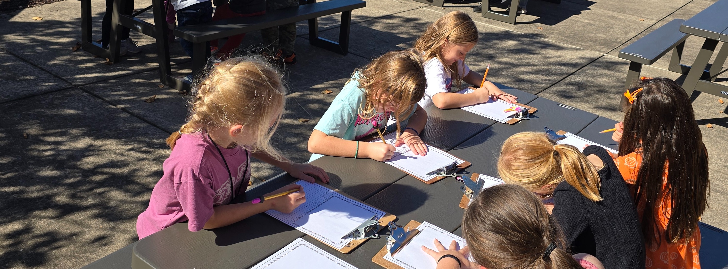 students writing outside