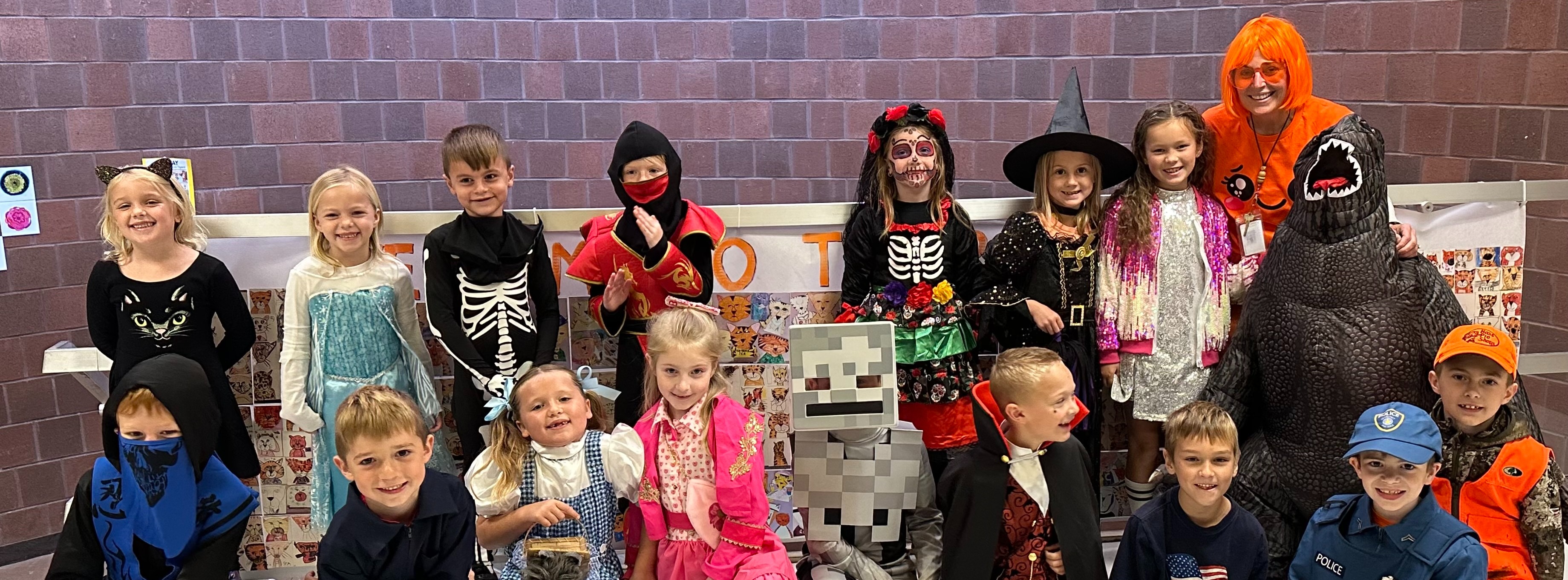 students in costumes posing for halloween photo