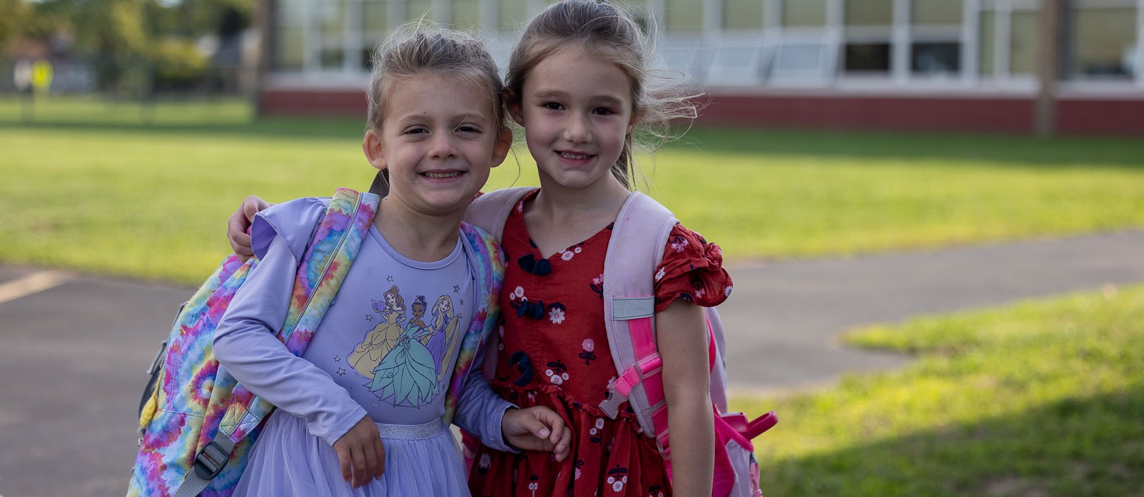 students with backpacks outside