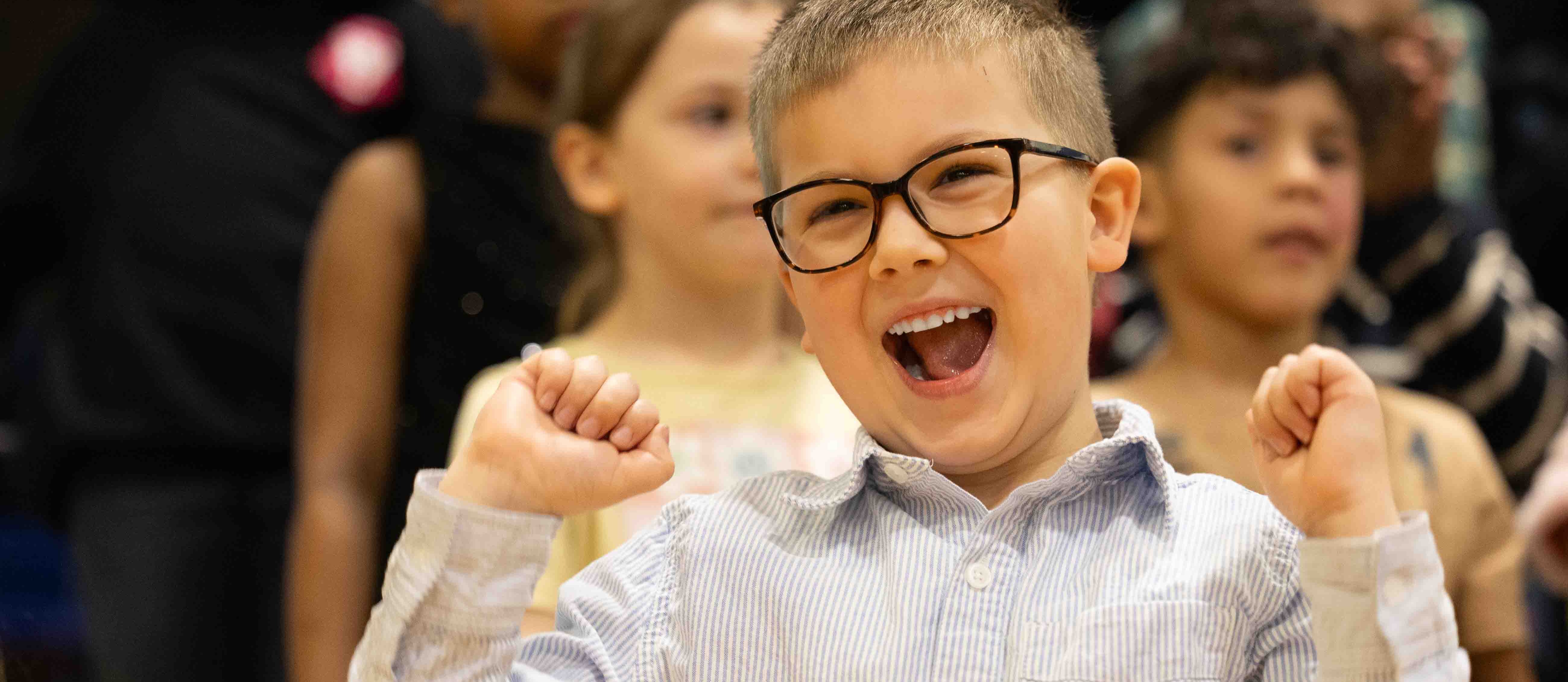 student smiles with glasses