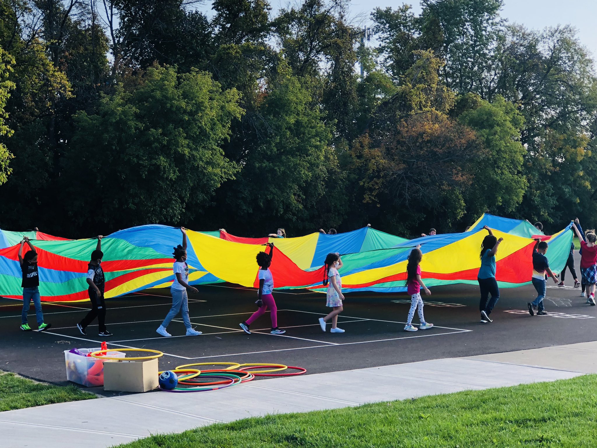 Students playing with a parachute in gym class