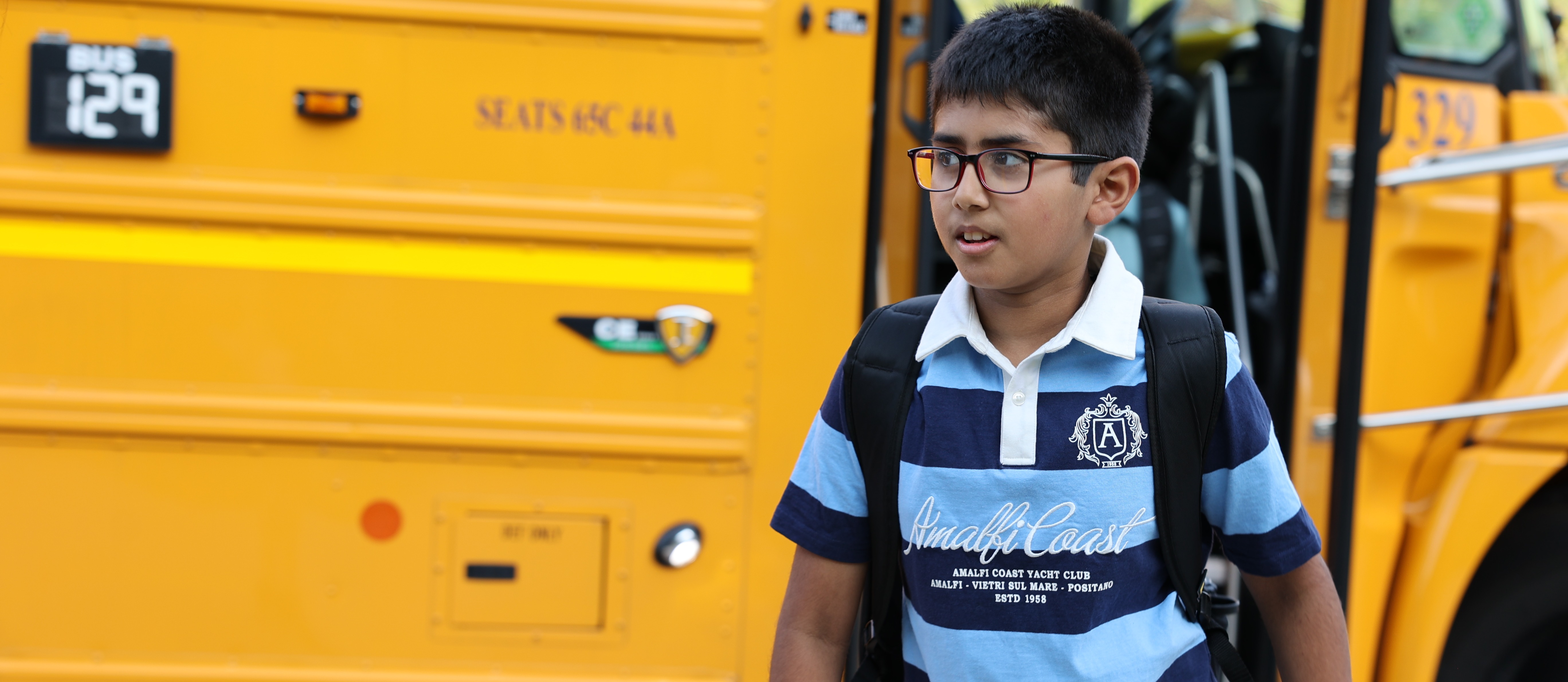 student getting off the bus