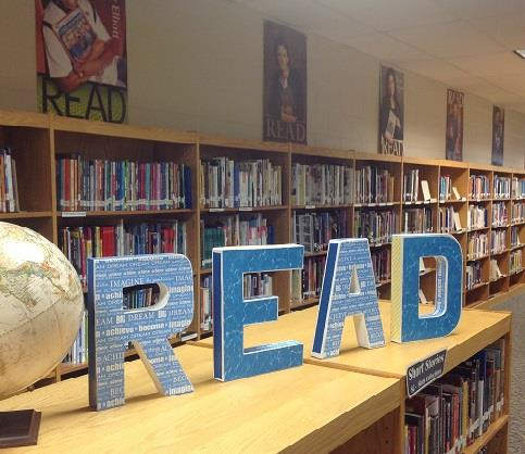 "Read" wooden letters on a library bookshelf