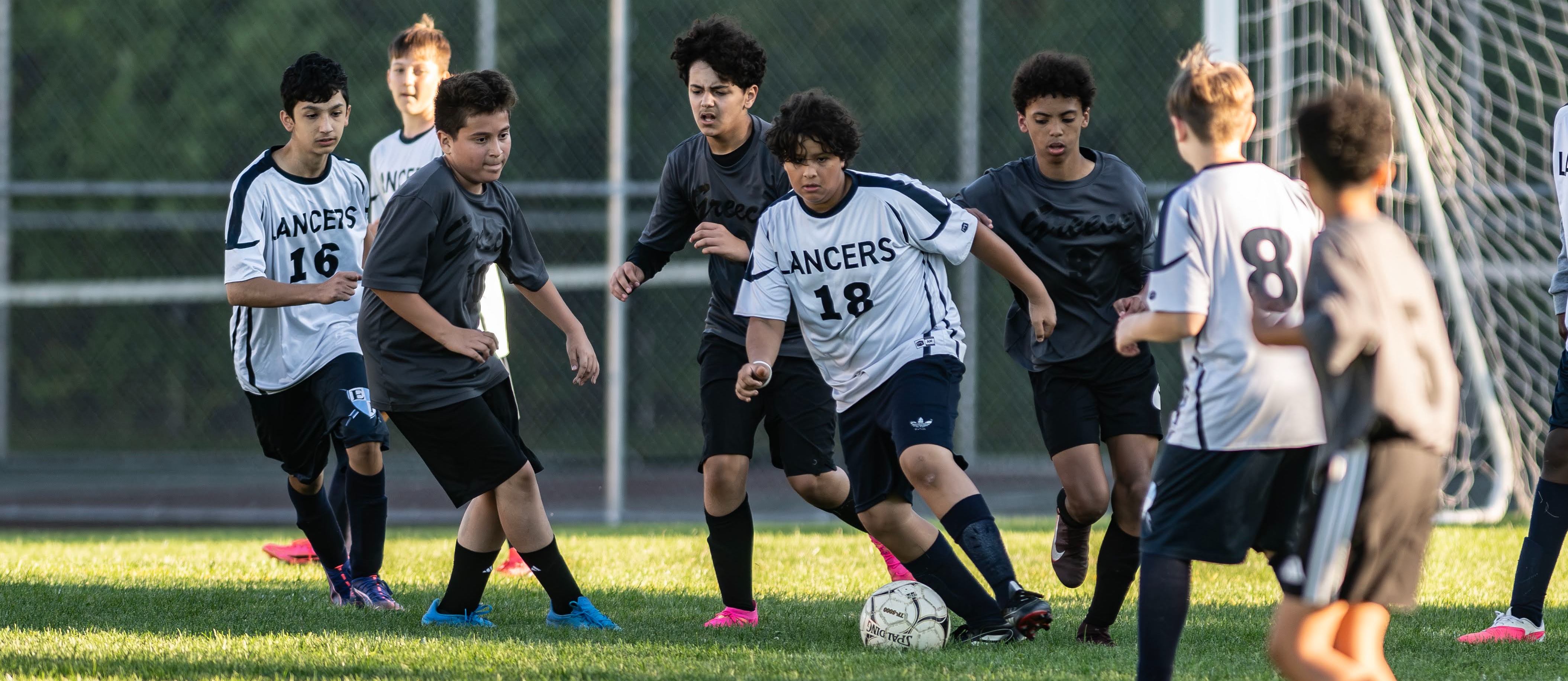 students play soccer on the field