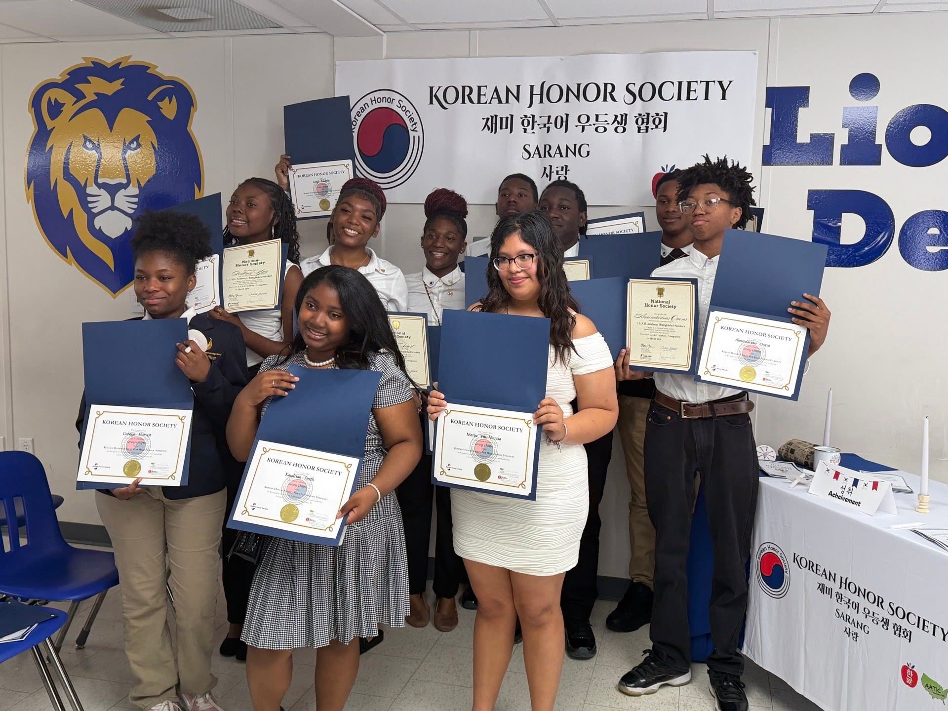 group photo of students holding awards for korean honor society