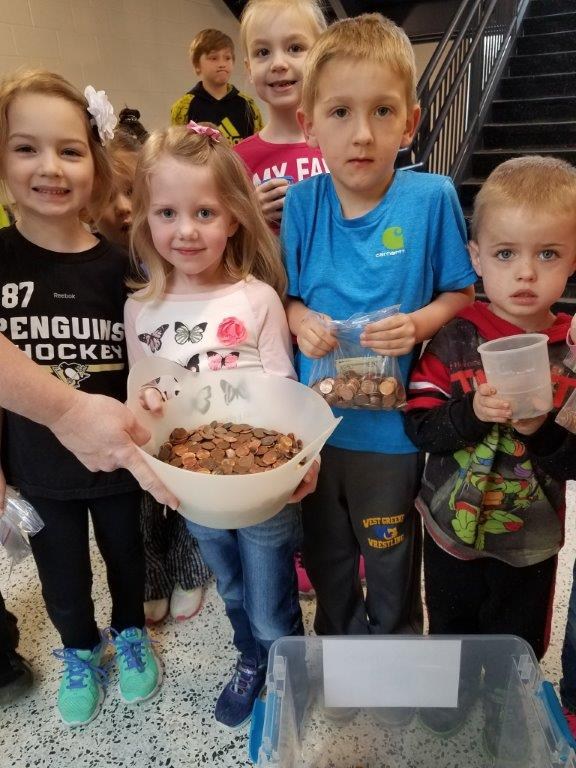 photo of students holding pennies