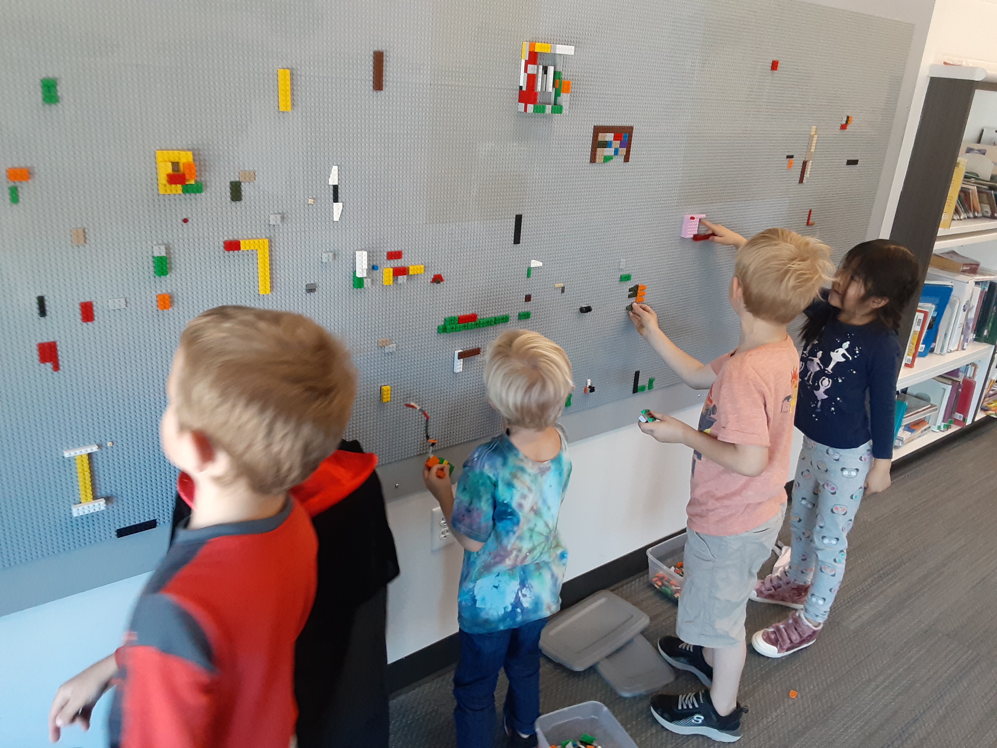 Students standing by the Lego wall