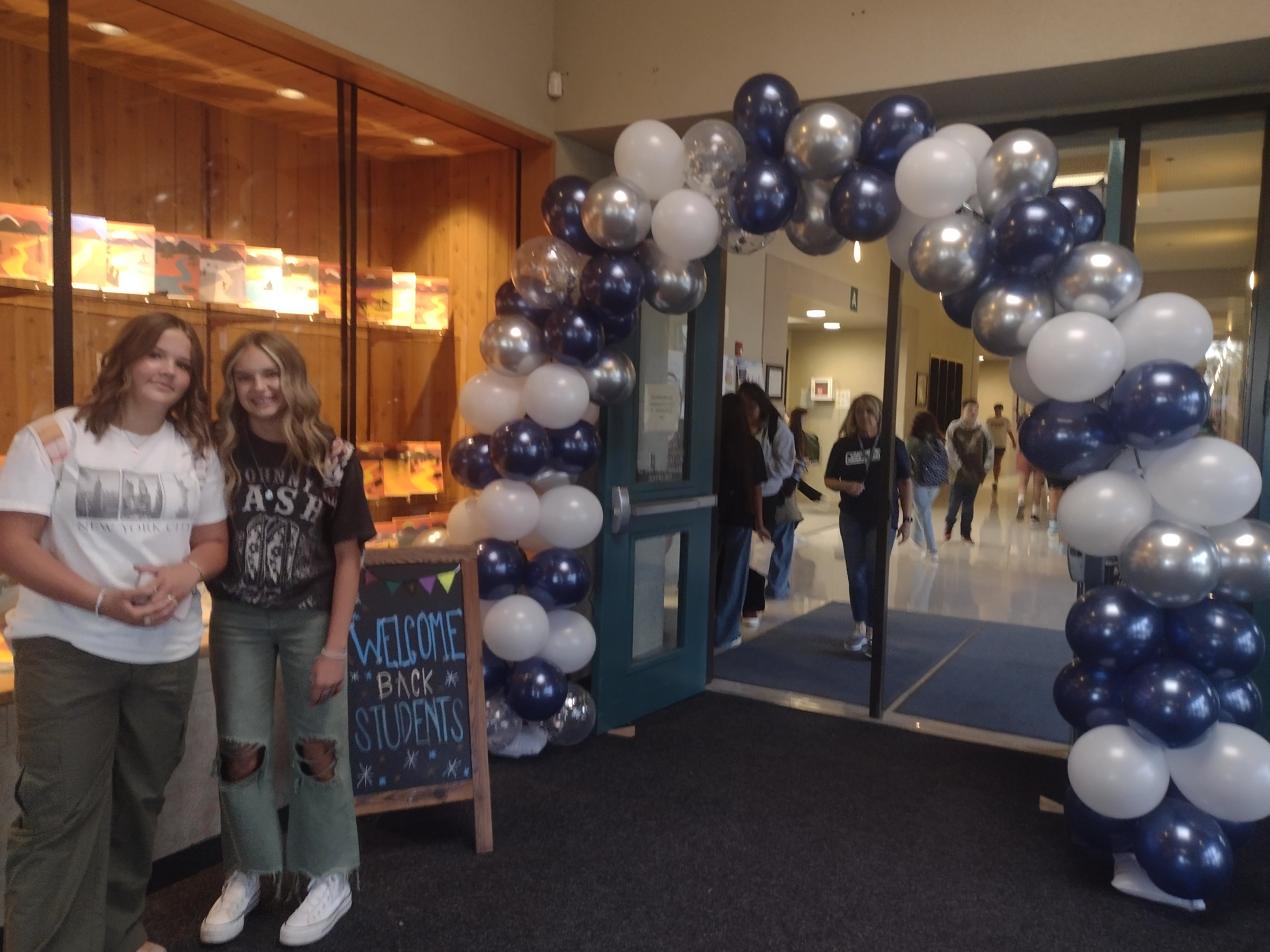 students standing by balloon arch