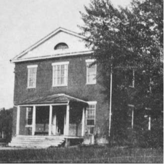 Black and white photo of the two-story Potomac Academy building.