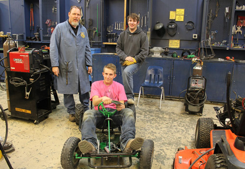 Teacher and student in shop class on go kart 