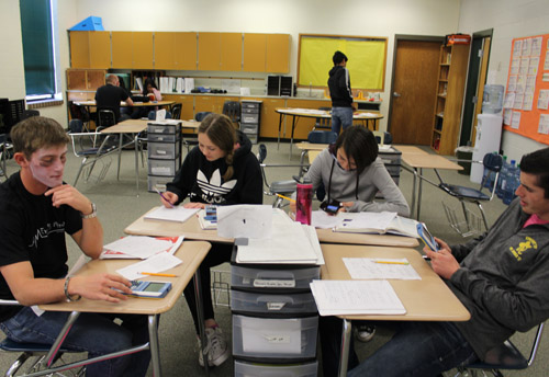 students working in a group at classroom desks