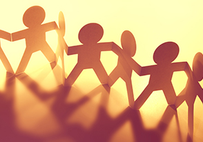 paper cut in the shape of stick figure people holding hands