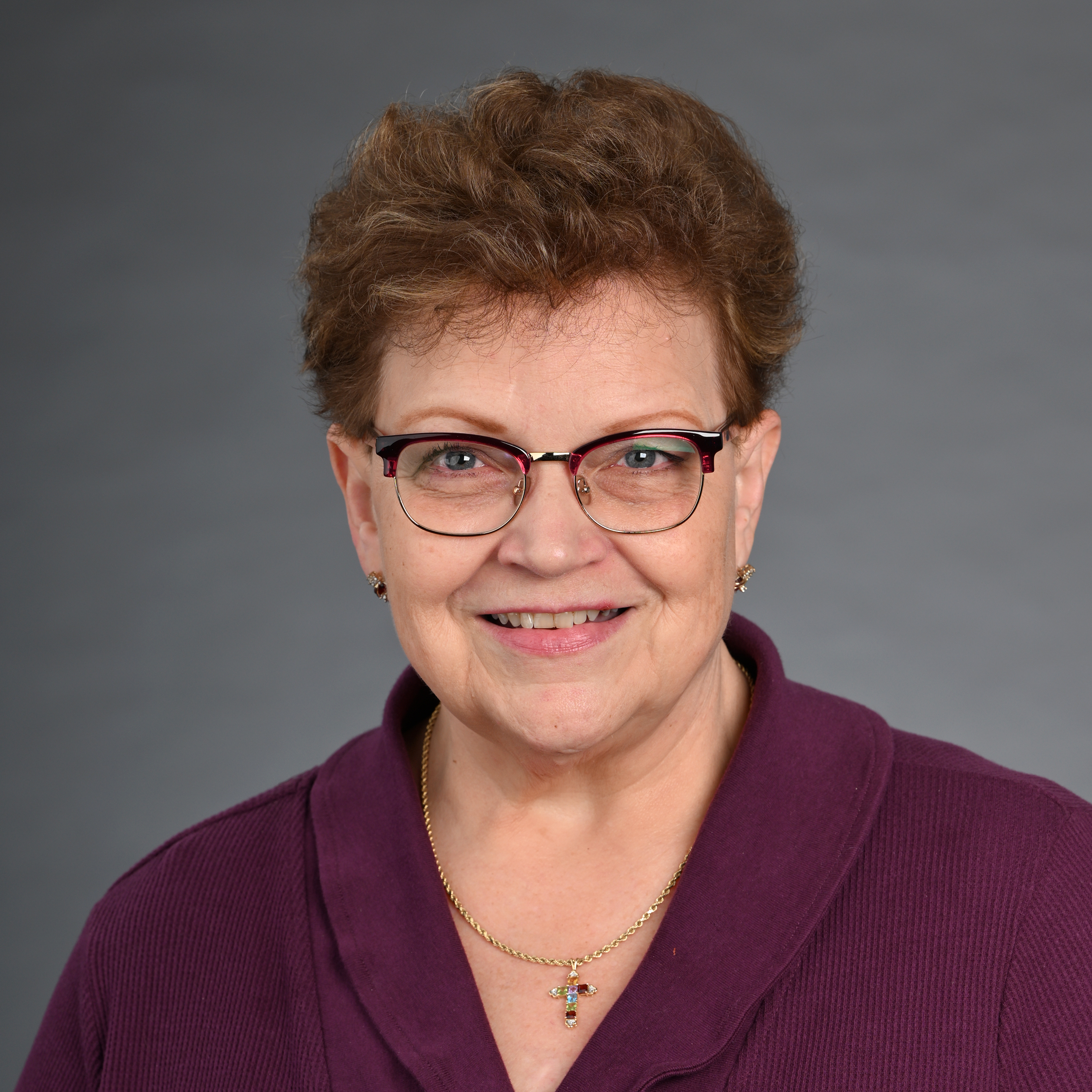 image of woman with shorter brown hair wearing glasses