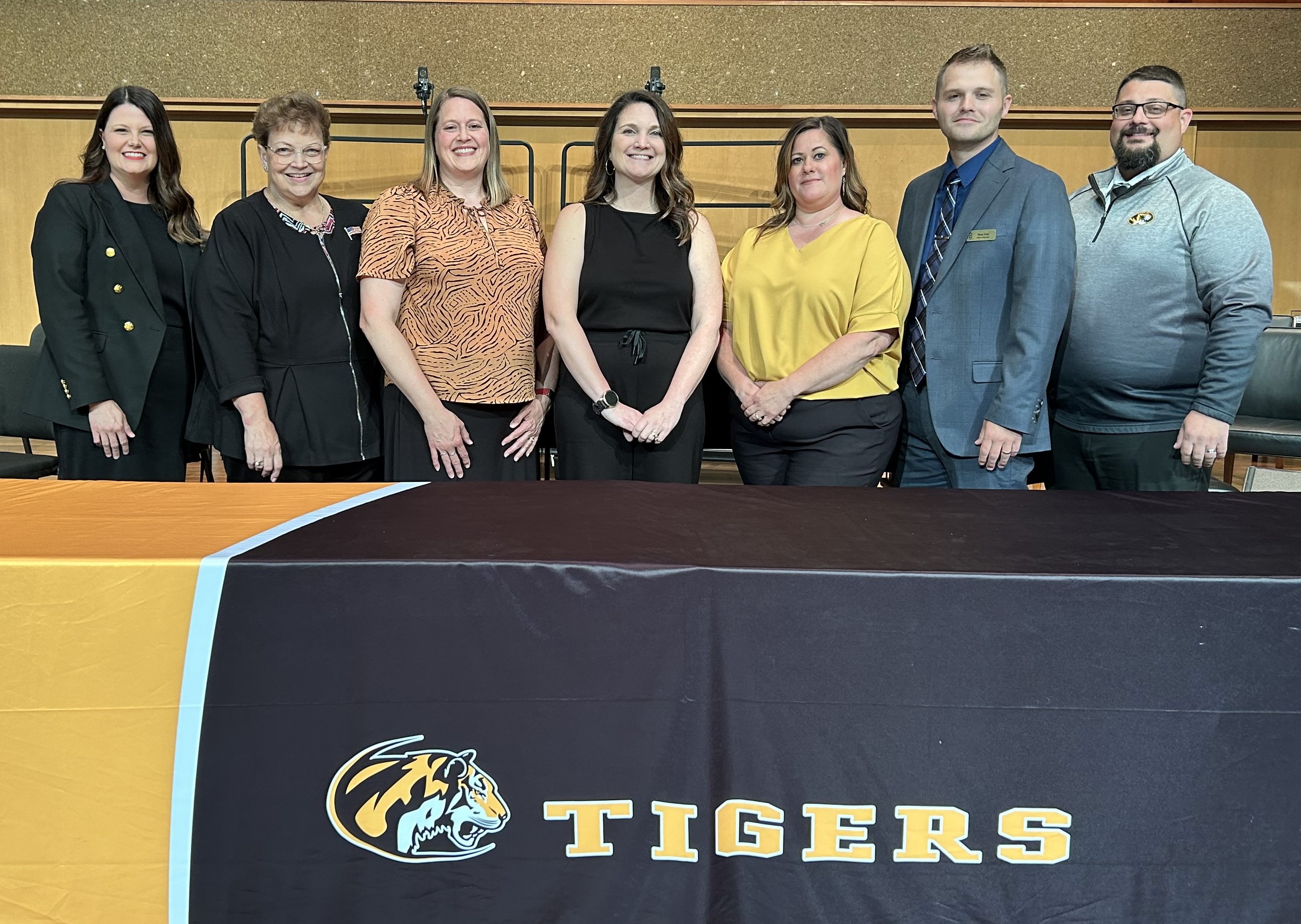 Board Members standing behind table at 23-24 Graduation Ceremony